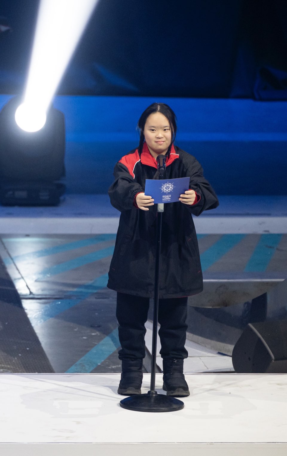 Megan Tang on stage to recite the Athletes' Oath in Turin, 2025